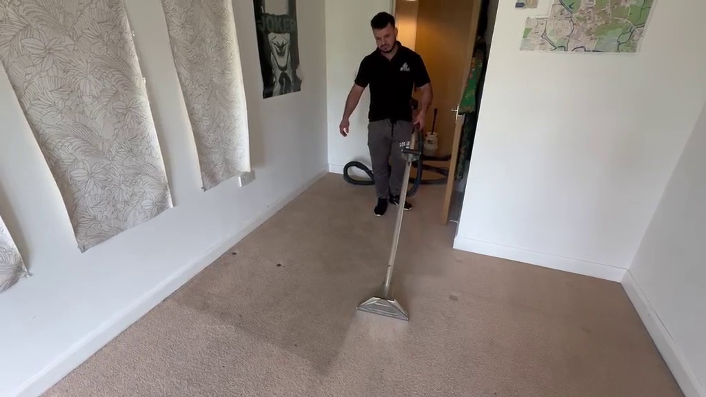 Hiago cleaning a carpet