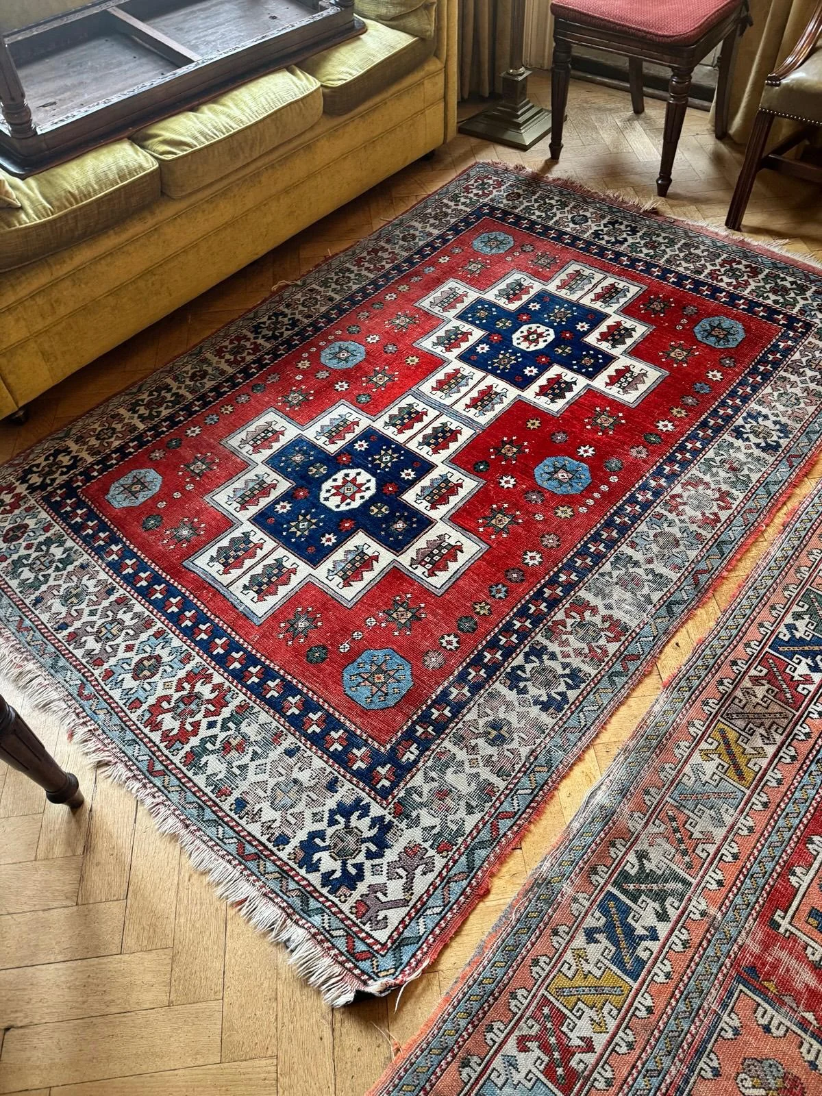 Detailed patterned rug on parquet flooring